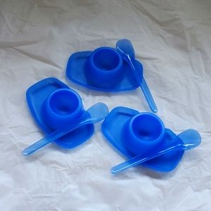 Egg cups saucers in blue with matching spoons.